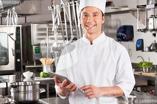 Image of Happy Chef Holding Tablet Computer