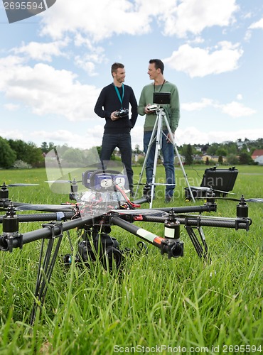 Image of UAV Helicopter And Technicians At Park