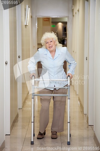 Image of Elderly Woman With Walker In Hospital Corridor