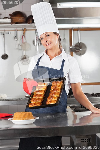 Image of Female Chef Holding Tray Of Baked Breads