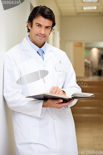 Image of Mid Adult Doctor Holding Book