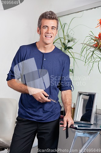 Image of Hairdresser Holding Scissors And Comb In Salon