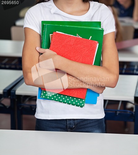 Image of Midsection Of Schoolgirl Holding Books