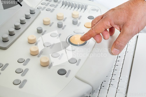 Image of Hand Operating Ultrasound Machine