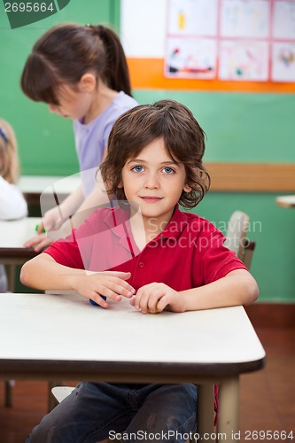 Image of Little Boy With Clay At Kindergarten