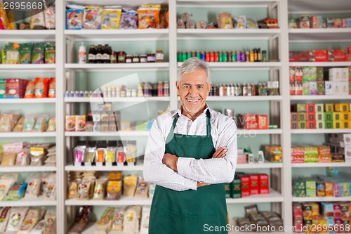 Image of Senior Male Owner Standing In Supermarket