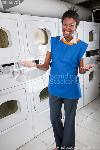 Image of Happy Female Helper Gesturing In Laundry