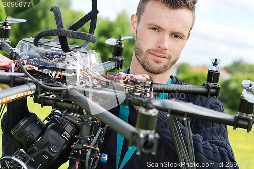 Image of Male Engineer With UAV Helicopter in Park
