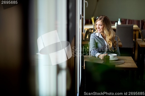 Image of Attractive Woman Alone in Cafe