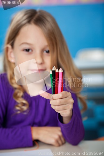 Image of Girl Holding Color Pencils In Kindergarten