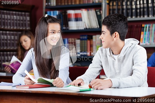 Image of Friends Looking At Each Other At Table In Library