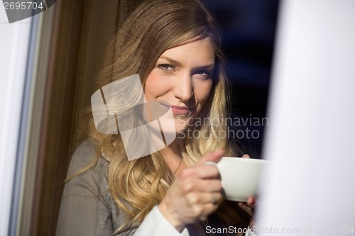 Image of Attractive Woman Holding Cup At Cafe