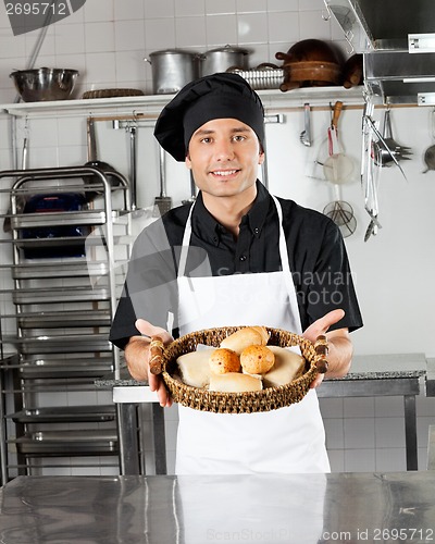 Image of Young Chef Holding Basket Of Breads