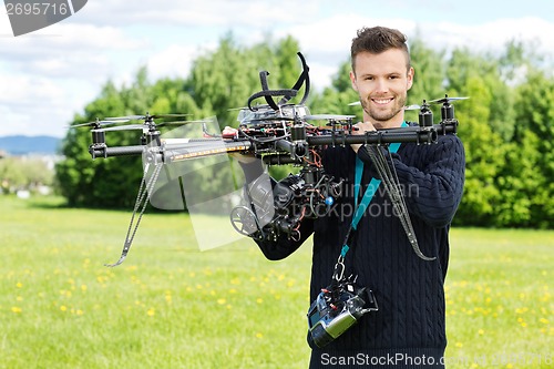 Image of Technician Holding UAV Octocopter in Park