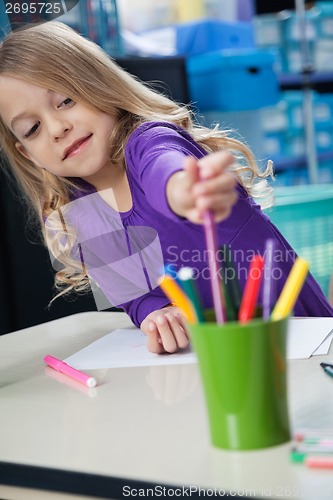 Image of Girl Picking Sketch Pen From Case In Classroom