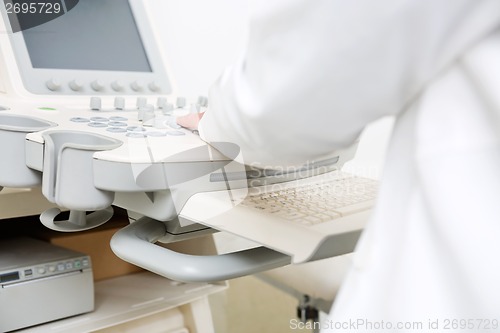 Image of Gynecologist Using Ultrasound Machine