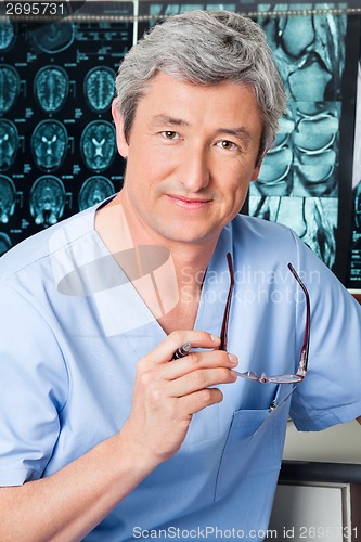 Image of Doctor Holding Glasses