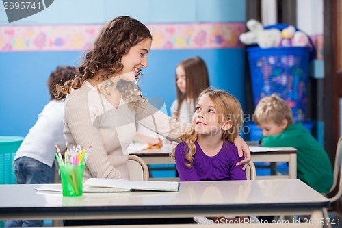 Image of Little Girl Looking At Kindergarten Teacher