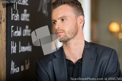 Image of Young Businessman Looking Away