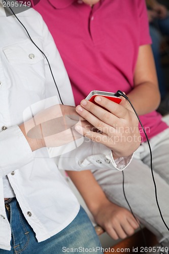 Image of Teenage Schoolgirls Using Mobilephone