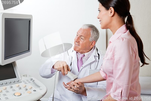 Image of Radiologist Scanning Female Patient's Hand