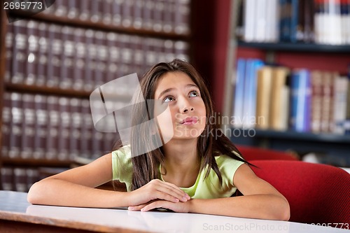 Image of Thoughtful Schoolgirl Looking Up In Library