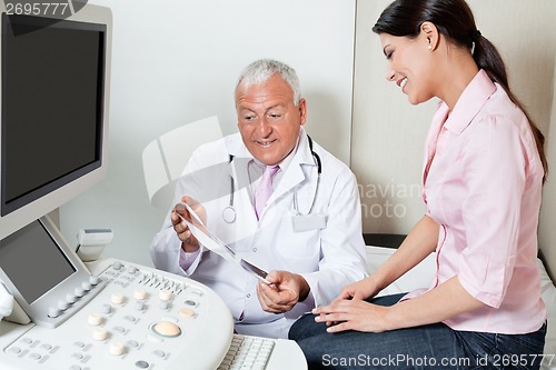Image of Radiologist Showing Ultrasound Print To Patient