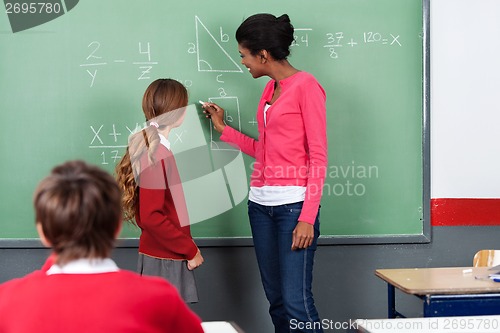 Image of Teacher Teaching Mathematics To Students On Board