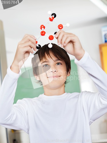 Image of Schoolboy Examining Molecular Structure In Classroom