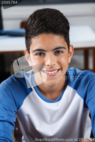 Image of Teenage Schoolboy Sitting In Classroom