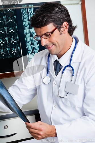 Image of Male Radiologist Reviewing X-ray