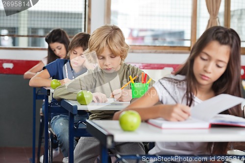 Image of Schoolchildren Studying At Desk