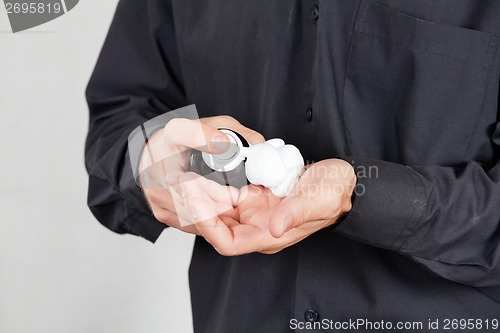 Image of Barber Spraying Shaving Foam On Palm