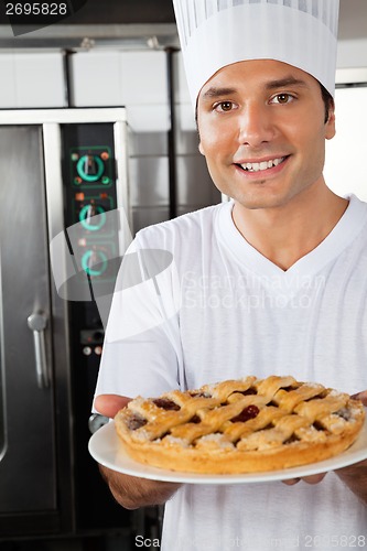 Image of Young Chef Presenting Sweet Dish