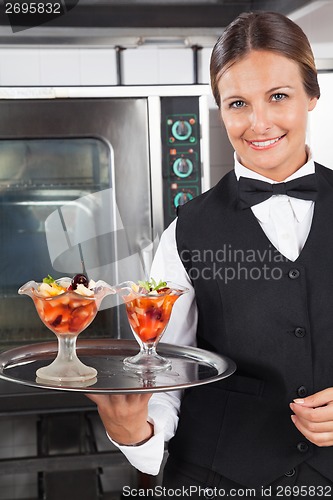 Image of Happy Waitress Holding Dessert Tray