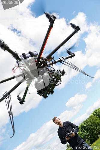 Image of Male Engineer Flying UAV Helicopter