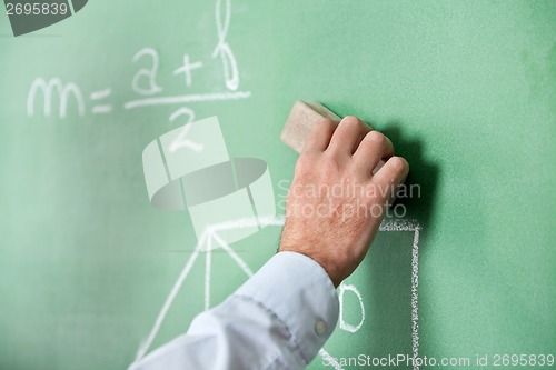 Image of Male Teacher'S Hand Wiping Board With Duster