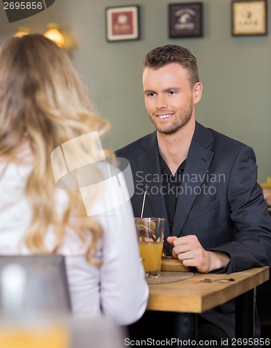 Image of Business man With Female Colleague At Coffeeshop