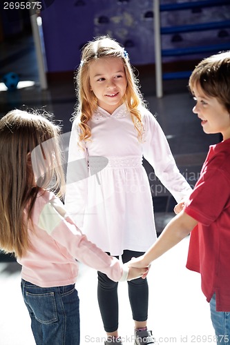 Image of Children Playing While Holding Hands In Preschool