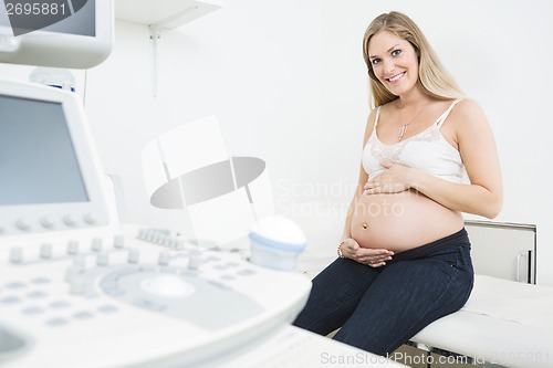 Image of Happy Pregnant Woman By Ultrasound Machine