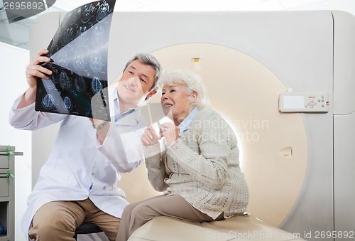 Image of Doctor And Patient Looking At CT Scan X-ray