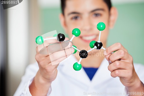 Image of Schoolboy Examining Molecular Structure In Lab