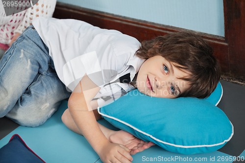 Image of Boy Lying On Heartshaped Pillow In