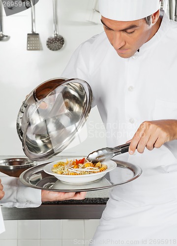 Image of Chef Checking Pasta Dish With Tong