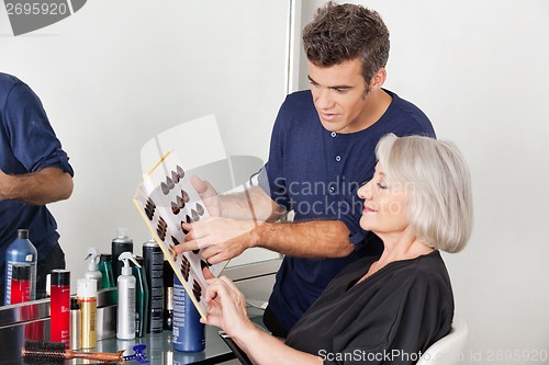 Image of Hairstylist Choosing Hair Color For Customer