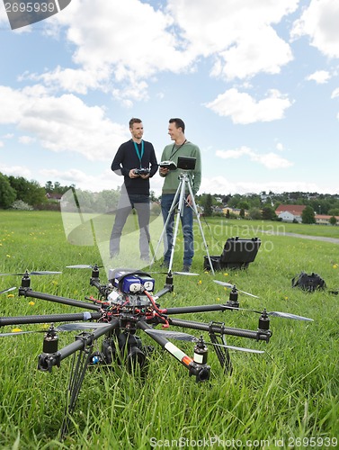 Image of UAV Helicopter And Technicians At Park