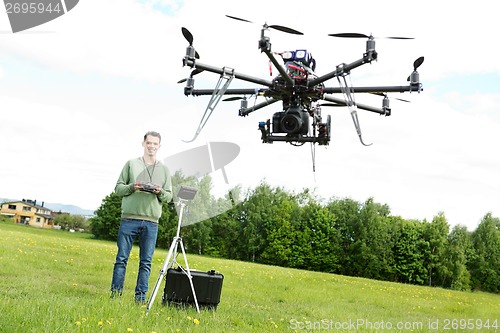 Image of Technician Flying UAV Octocopter in Park