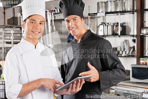 Image of Happy Chefs Holding Digital Tablet