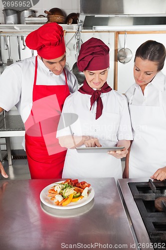 Image of Chefs Using Digital Tablet In Kitchen