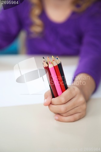 Image of Girl Holding Of Colored Pencils In Classroom